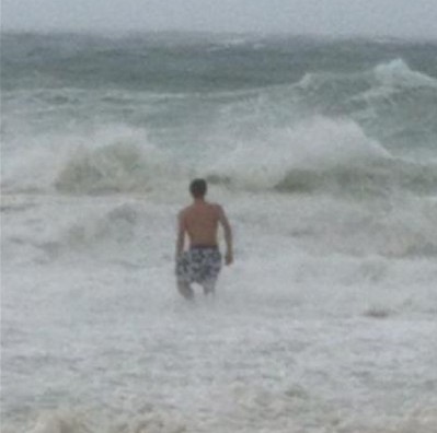 boy standing in ocean surf